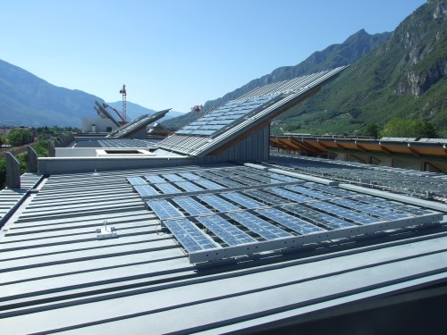 Glass-Tedlar modules (a) mounted on metal frames fixed to the buildings’ roof © FAR System Srl